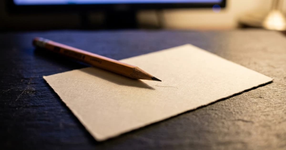 A blank comment card with a pencil resting on it, waiting for one answer